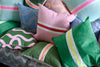 Spaghetti lumbar cushion in green + highlighter pink