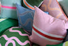 Spaghetti lumbar cushion in pink + neon orange